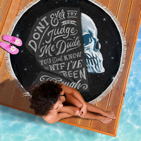 Black round beach blanket with skull portrait and fringed white edge