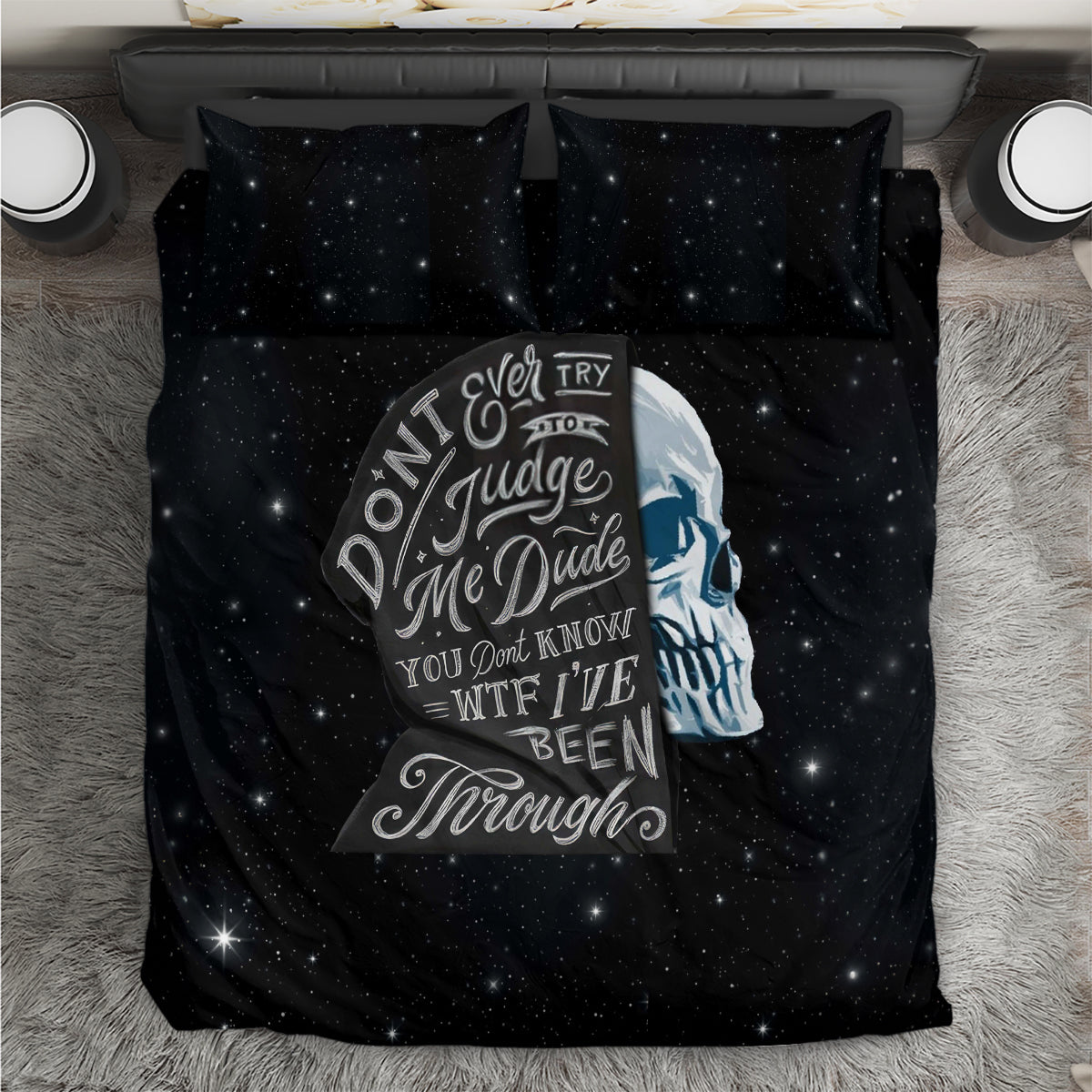 Black starry bedding set with central skull graphic on duvet and two matching pillows