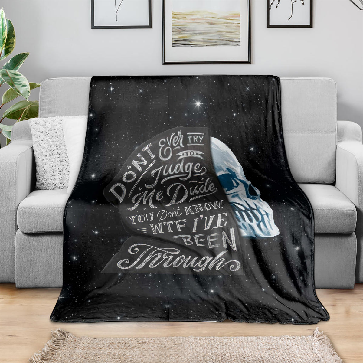 Black skull graphic fleece blanket with starry background and bold quote design