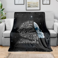 Black skull graphic fleece blanket with starry background and bold quote design