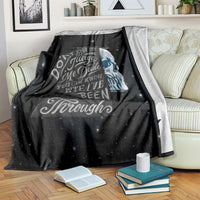 Black skull quote blanket on couch arm, star-speckled design with large face
