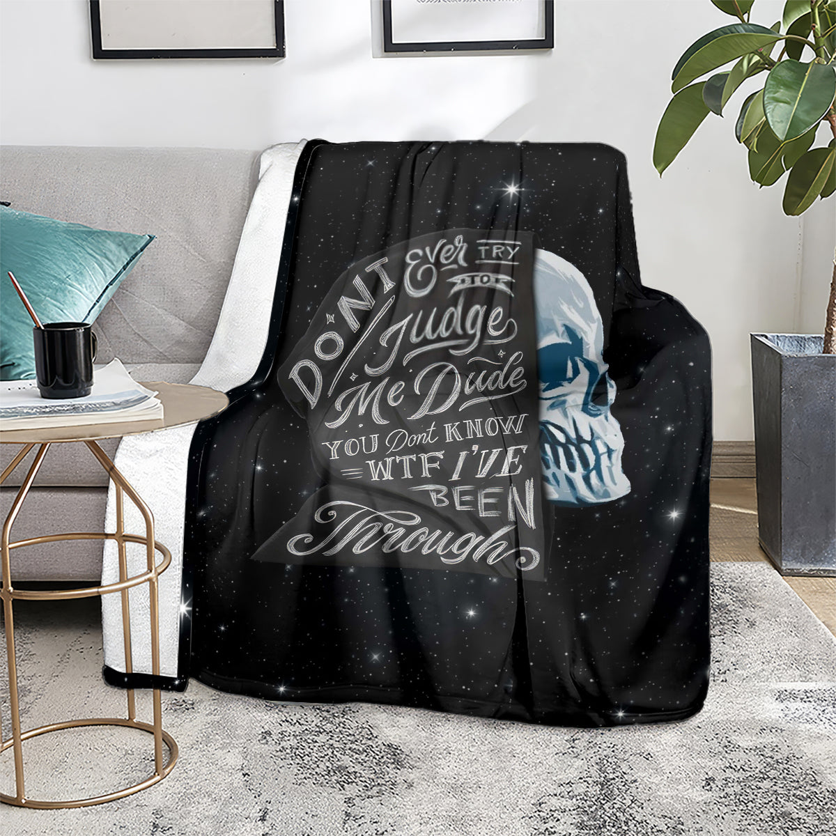 Black skull quote blanket on couch, starry pattern and circular text artwork