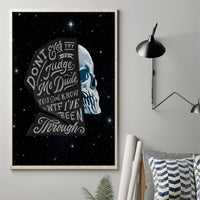 Framed black canvas wall art with blue skull portrait and quote text on starry backdrop