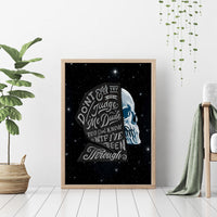 Framed wood canvas wall art with blue skull profile and bold script quote on starry background