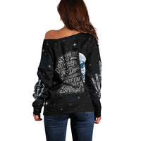 Black off-shoulder sweater with galaxy speckle and graphic text and skull hand print