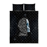 Black quilt bed set with quilted grid and blue skull graphic, plus two pillowcases