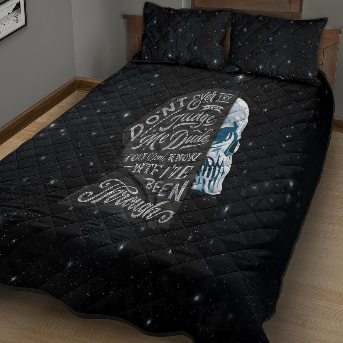 Black quilt bed set with quilted grid, blue skull graphic, and two matching pillows