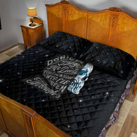 Black quilt bed set with blue skull text graphic and two quilted pillowcases