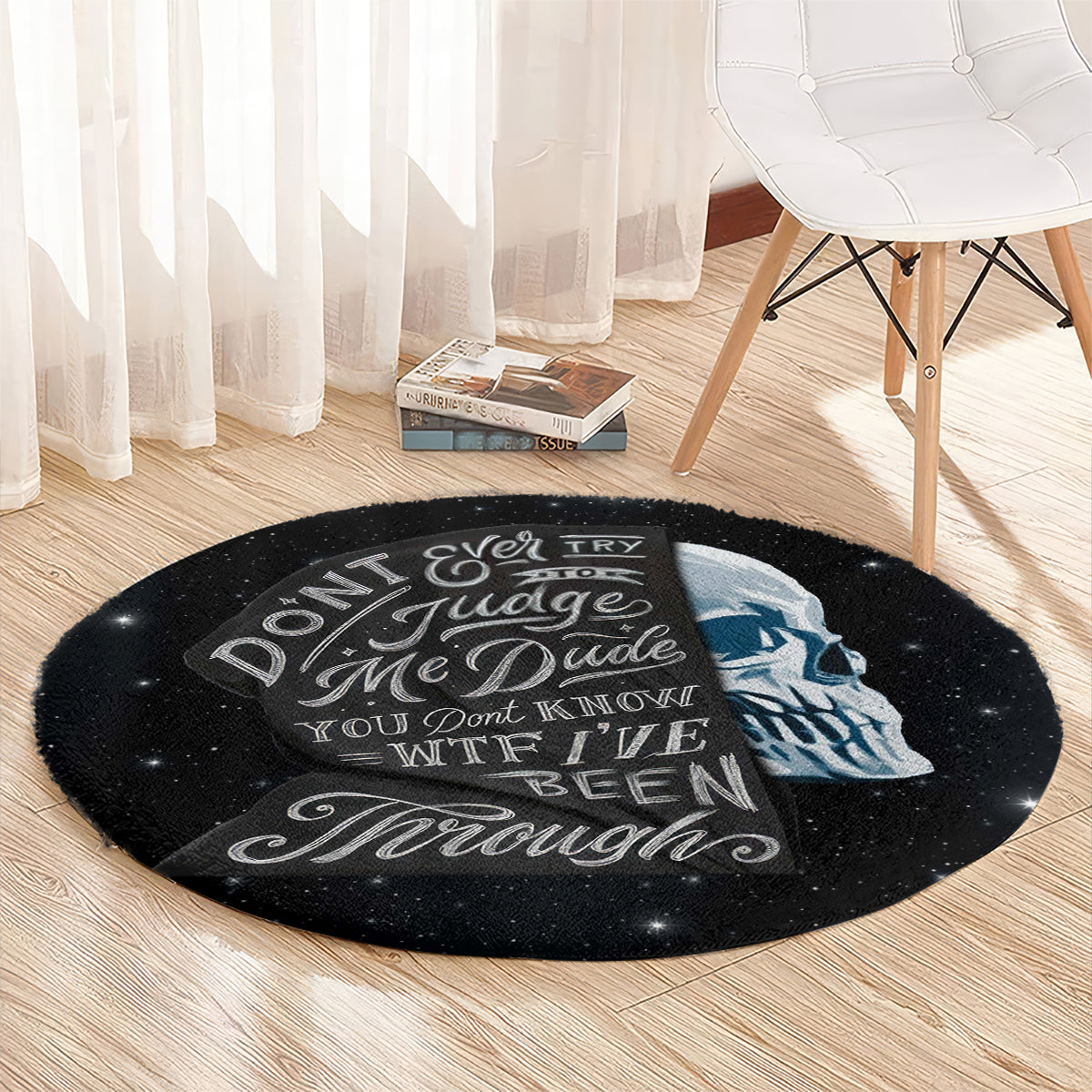Round black area rug with blue skull portrait and white quote text, starry speckle