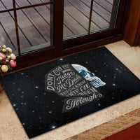 Black rubber doormat with sad skull design and “Jungle Me Dude” typography