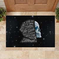 Black rubber doormat showing sad skull face and layered “Don’t Ever Try” style lettering