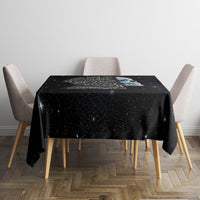 Black skull tablecloth on a square table with starry speckled print and skull graphic