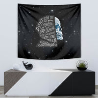 Black galaxy-style tapestry showing a blue skull profile and vintage lettering