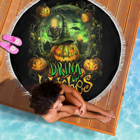 Round black beach blanket with witch and pumpkin “Drink Up Witches” graphic, fringe edge