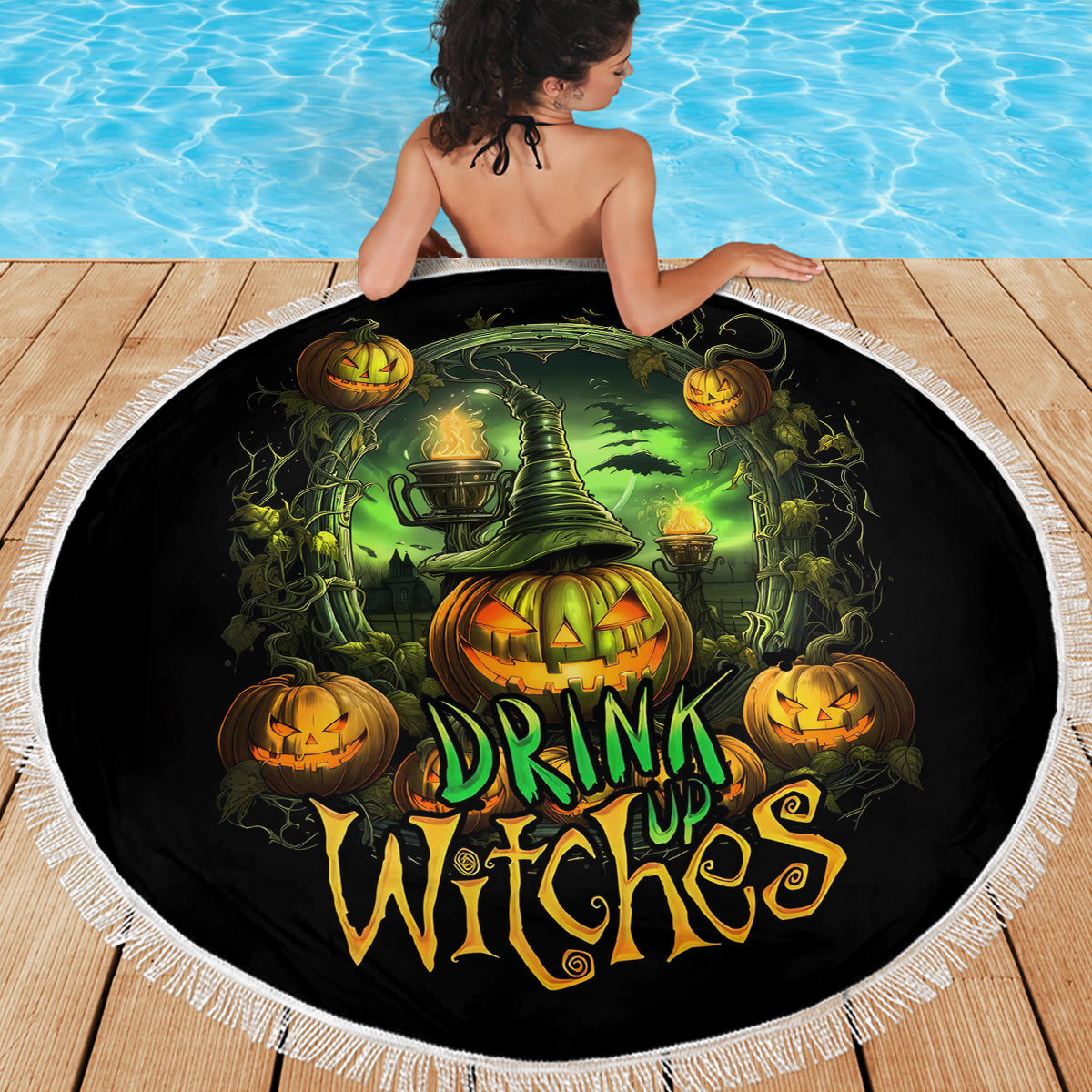 Round black beach blanket with Halloween witch scene, pumpkins and cauldron, fringed border