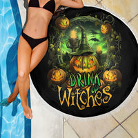 Round black beach blanket draped poolside, witch and pumpkin artwork with “Drink Up Witches”