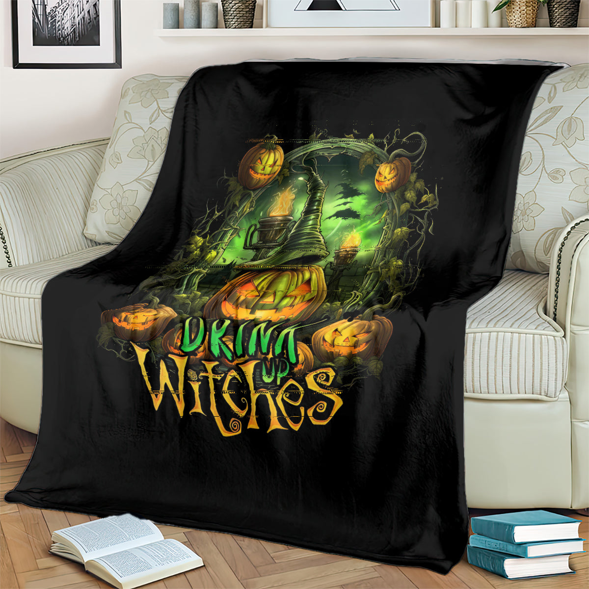 Black halloween witches throw blanket draped on a couch with green cauldron and jack-o-lanterns
