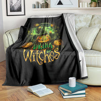 Black halloween throw blanket with green cauldron, pumpkins, and drink up witches graphic