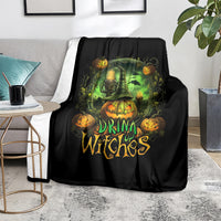 Black halloween throw blanket featuring glowing green cauldron and drink up witches lettering