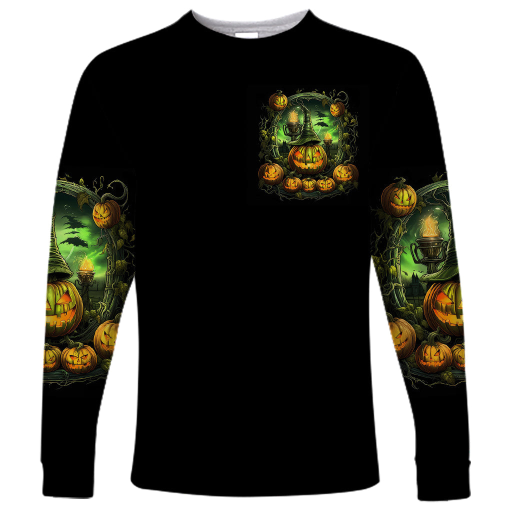 Black long-sleeve shirt with small green pumpkin skull chest graphic