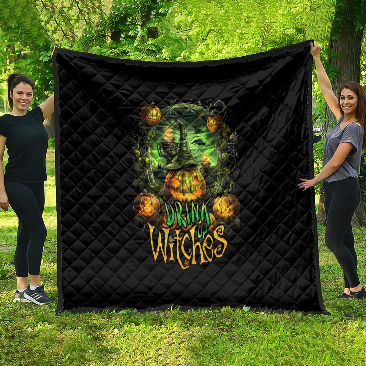 Black quilted Halloween quilt with green witch skull art and glowing pumpkin accents