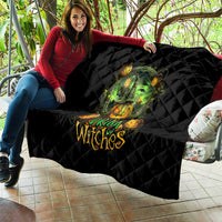 Black quilted Halloween quilt draped on sofa with green witch skull art and pumpkin lights
