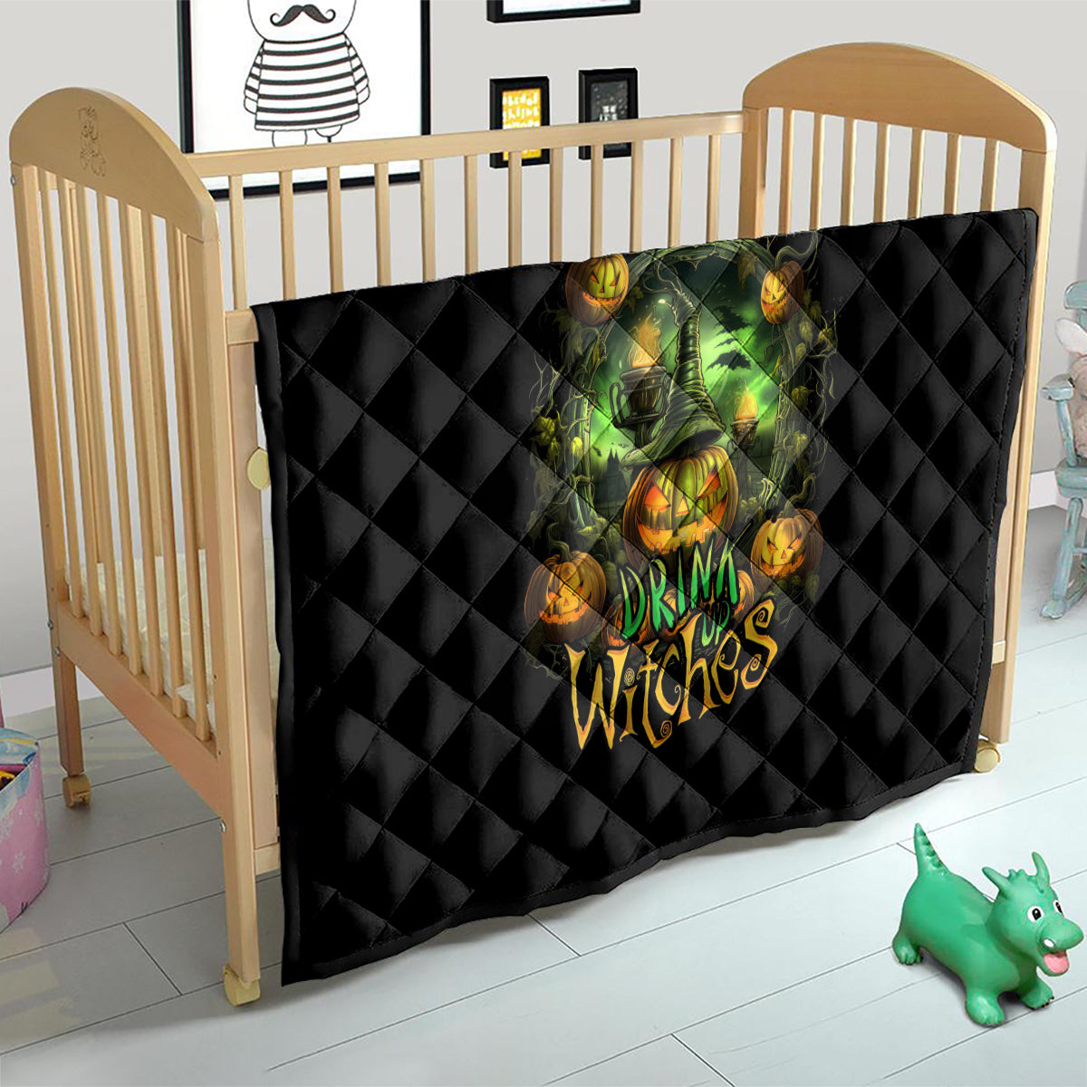 Black quilted Halloween quilt on wooden crib with green witch skull and orange pumpkin artwork