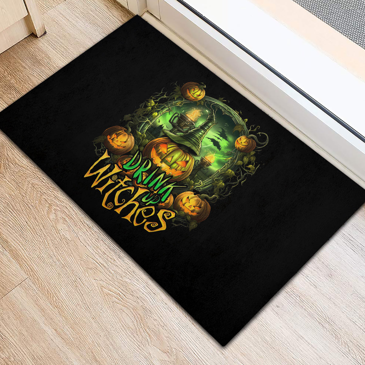 Black rectangular rubber doormat with green witch pumpkin graphic and 'Drink Witches' text