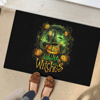 Black rubber doormat with green witch pumpkin art and 'Drink Witches' centered text