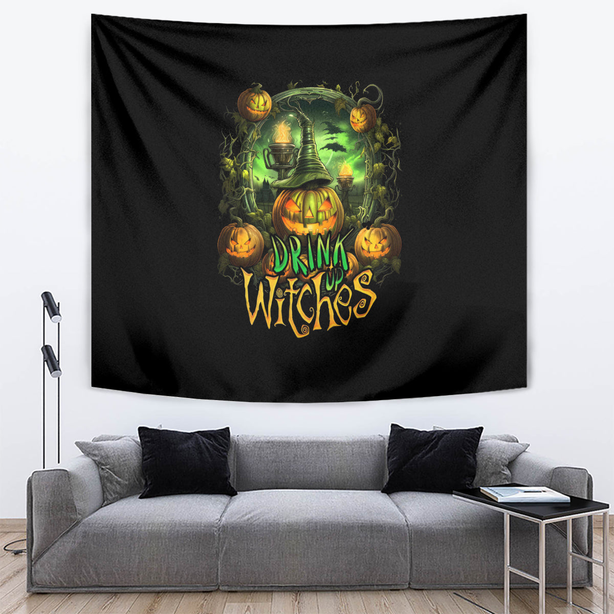 Black Halloween tapestry draped in a room, with witch pumpkins and 'DRINK UP WITCHES' text