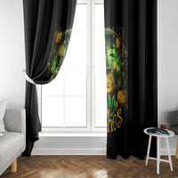 Black window curtain panels with green glowing witch and pumpkin skull artwork by the window