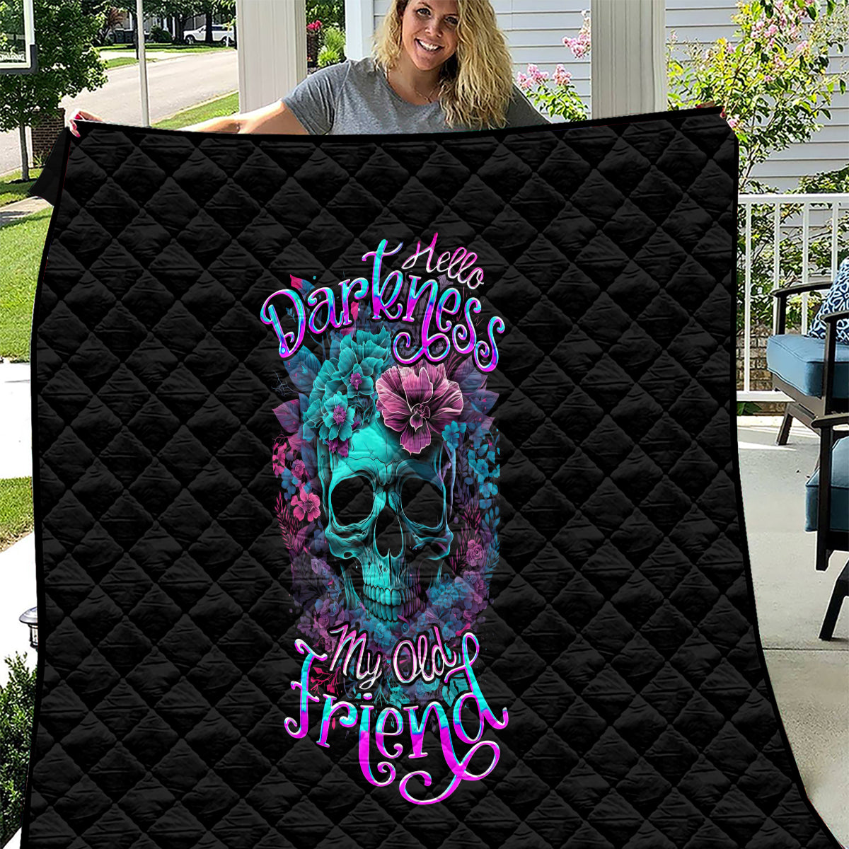 Black quilt with diamond quilting and neon skull-flower artwork, large center