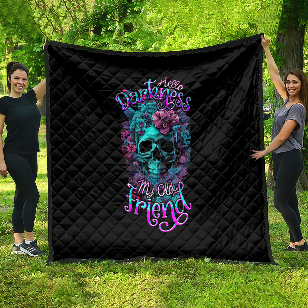 Black quilt with diamond stitching and colorful skull-flower graphic, centered
