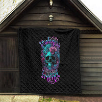 Black quilt with diamond stitching and colorful skull-flower design, hanging