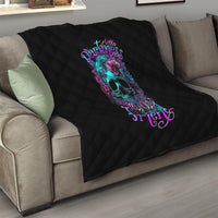 Black quilt with diamond quilting and centered skull-flower graphic on couch