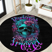Black circular rug with centered turquoise skull, purple flowers, and pink-blue cursive text
