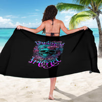 Black sarong with purple skull and flowers graphic, worn as wrap with ties.