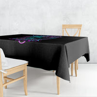 Black tablecloth with colorful skull and floral graphic, draped over tabletop corner