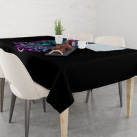Black rectangular tablecloth with colorful skull and floral graphic near table center