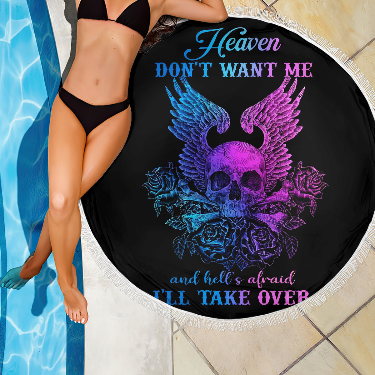Black round beach blanket close-up center print with skull-wings graphic, fringed edge