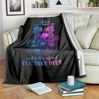 Black skull blanket with blue and purple wings and roses, partially folded over sofa