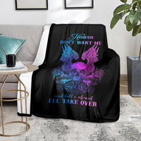 Black skull blanket spread on sofa with blue/purple winged skull and rose graphic