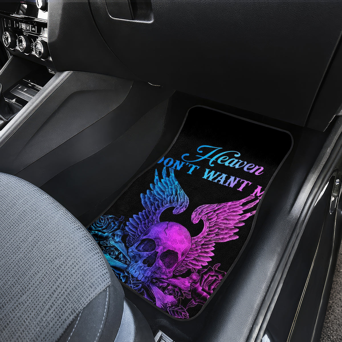Black car floor mat with neon skull-wing graphic and 'Heaven don't want'