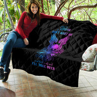 Black quilt blanket with diamond quilting and purple/blue winged skull graphic on couch