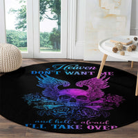Black round rug with winged skull artwork in blue and purple and quote border