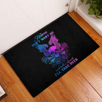 Black doormat with purple skull, blue wings, and decorative slogan lettering