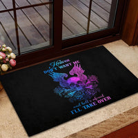 Black doormat with purple-and-blue skull-and-wing artwork near doorway