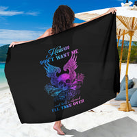 Black sarong with large purple skull-wing design and blue slogan, draped over one arm