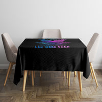 Black tablecloth with neon blue and purple skull wing artwork centered on a dining table