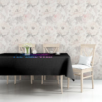 Black tablecloth with blue and purple skull wing text graphic on the tabletop